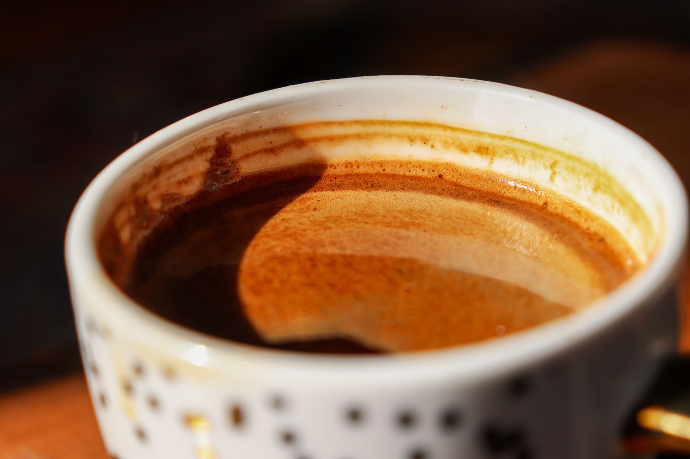 A close-up of an espresso shot with a rich crema